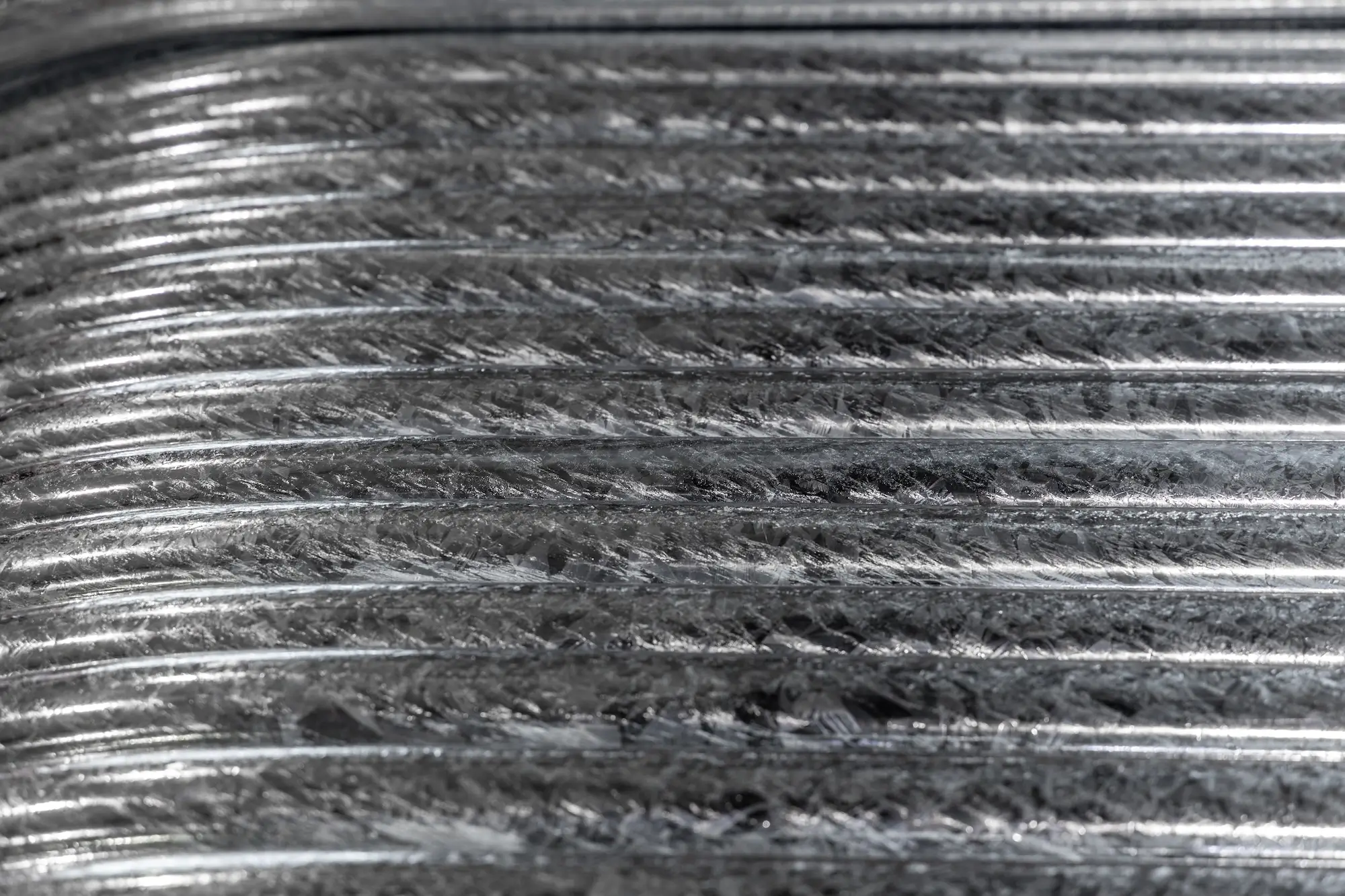 Close-up of hot-dip galvanized steel surface showing high-quality crystallization pattern.