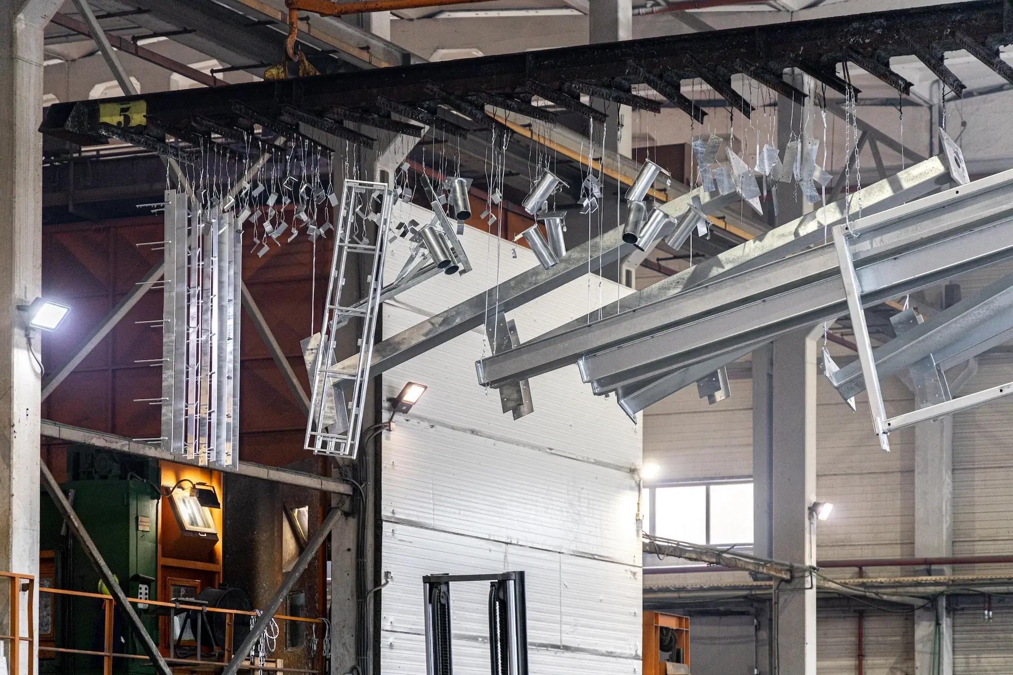 Movement of various metal structures and parts on the hot-dip galvanizing line conveyor.
