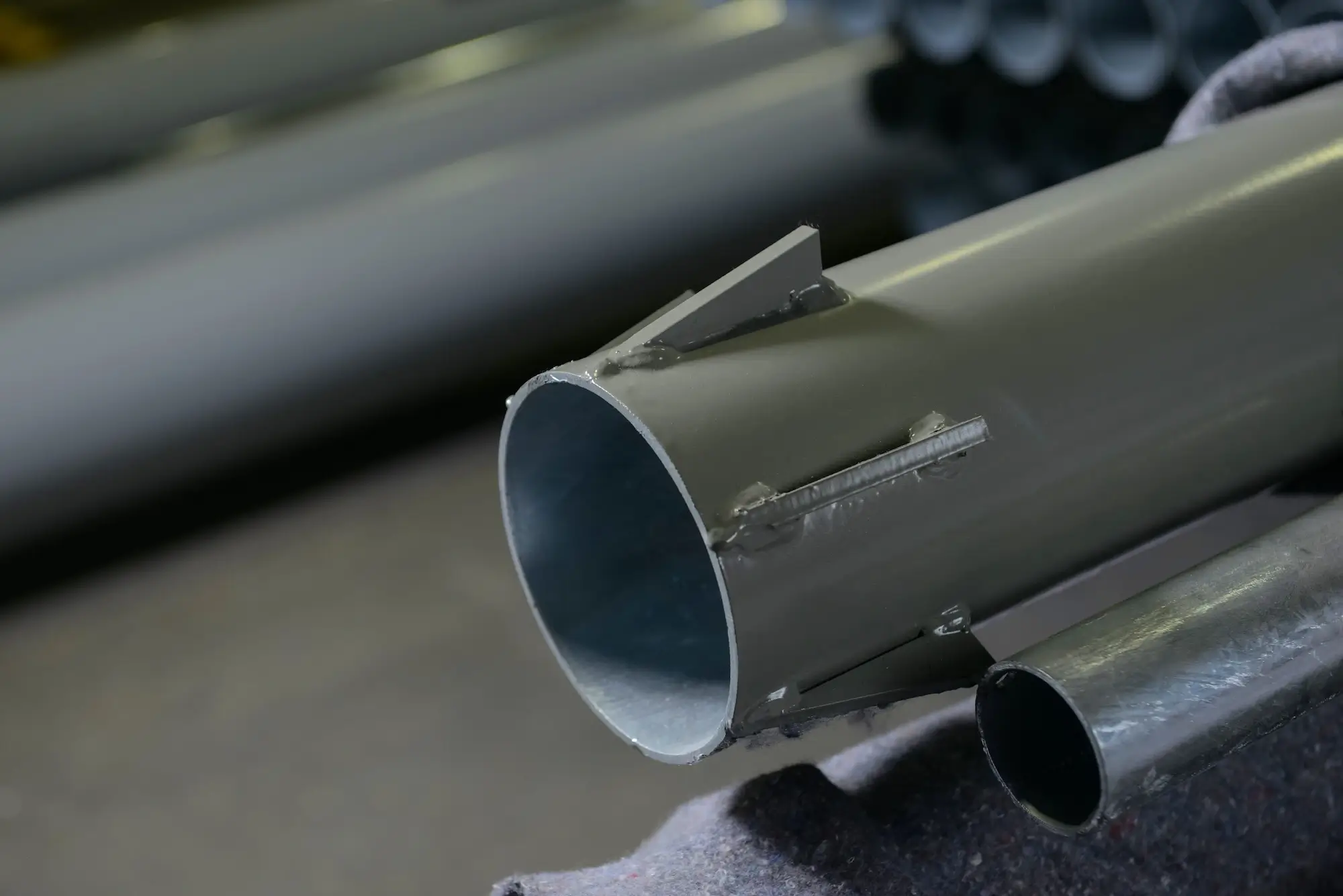 High-quality painted metal pipe detail with welded elements, ready for operation.