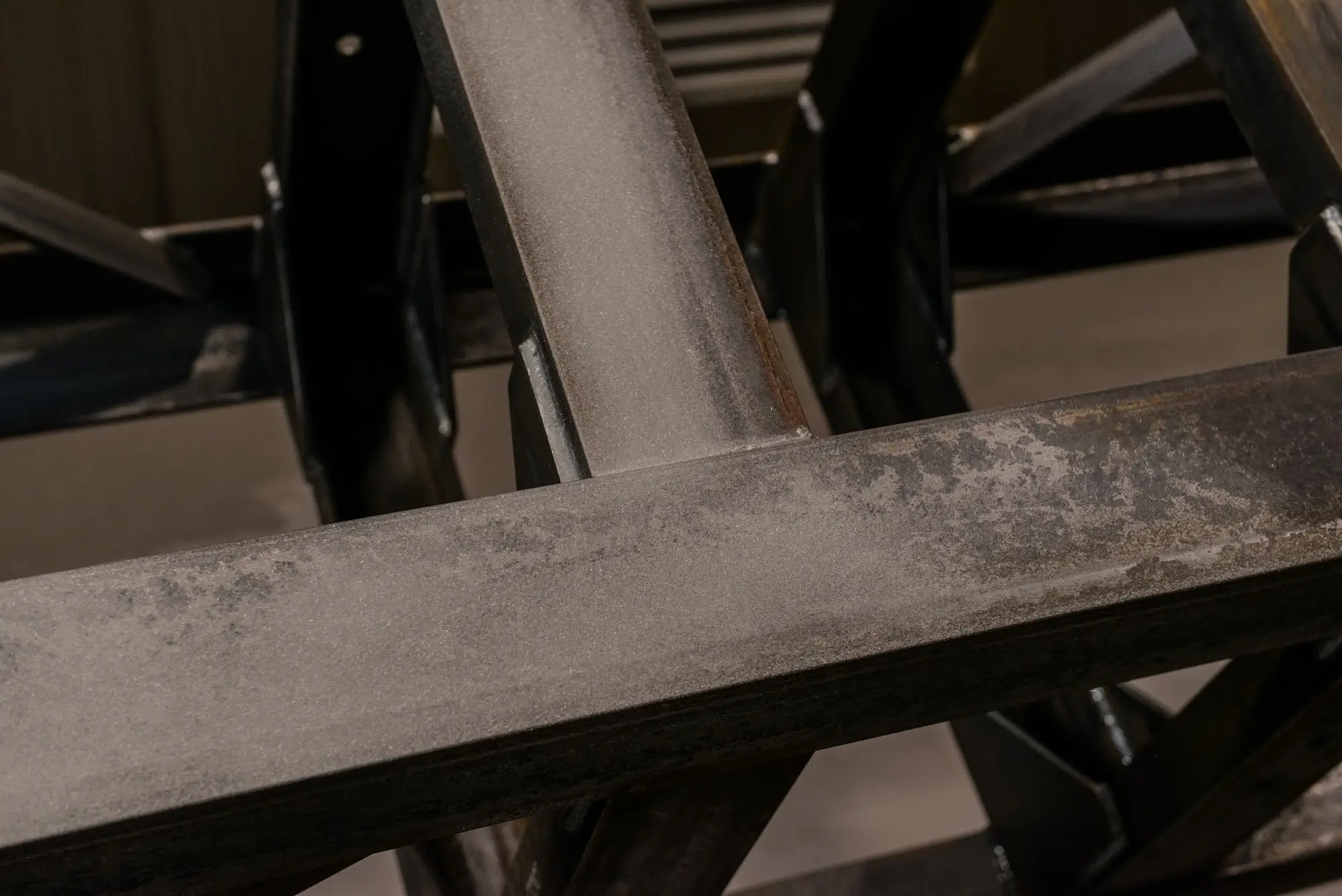 Rough texture of shot-blasted steel surface close-up, ensuring better paint adhesion.
